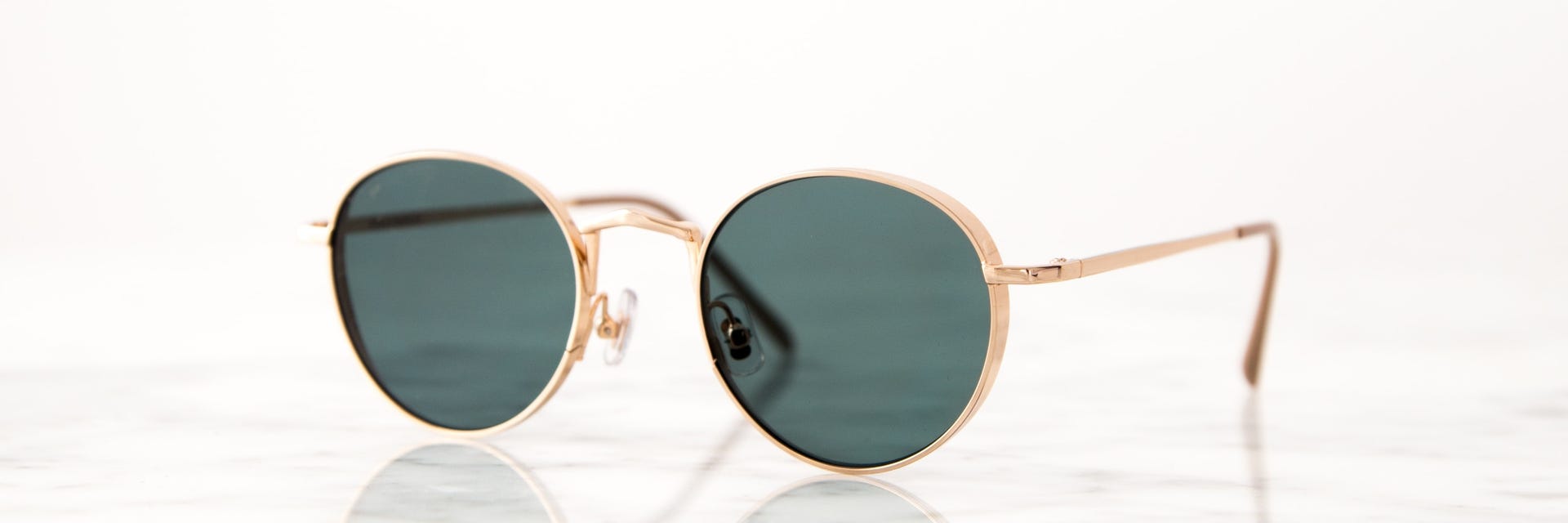 vintage sunglasses with dark lenses and gold frame